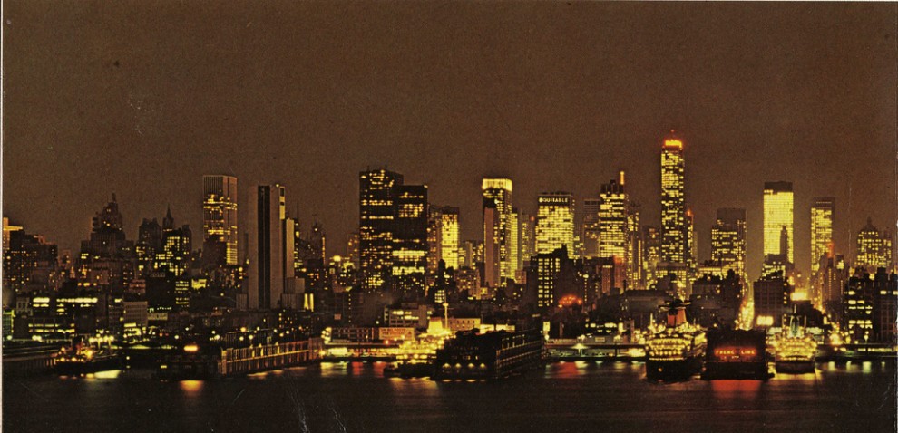 Night view of the evolving Midtown Manhattan skyline looking east from Hudson River. January 1969.