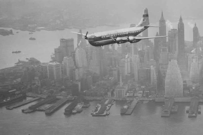 A Boeing Stratocruiser flies low over Manhattan, 1949.