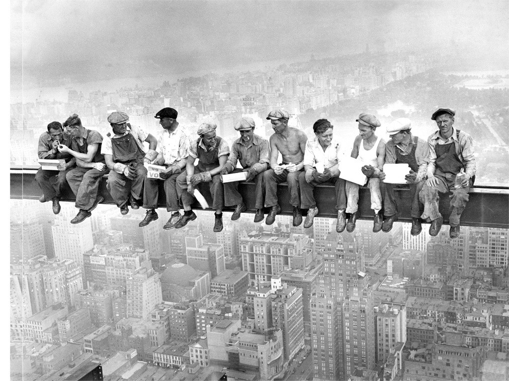 Fearless workers resting on a beam during the construction of the Empire State Building (1930).