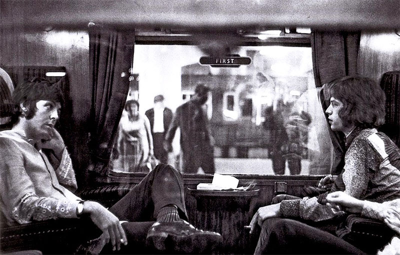 Paul McCartney and Mick Jagger on a train at Euston Station on their way to Bangor. 5th August, 1967.