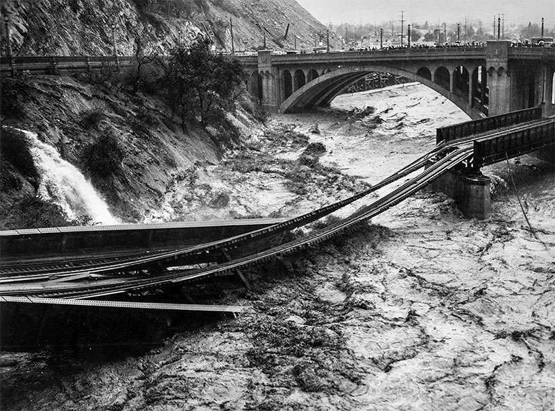 Flood waters from the Los Angeles River destroy Southern Pacific railroad bridge. March 2, 1938.