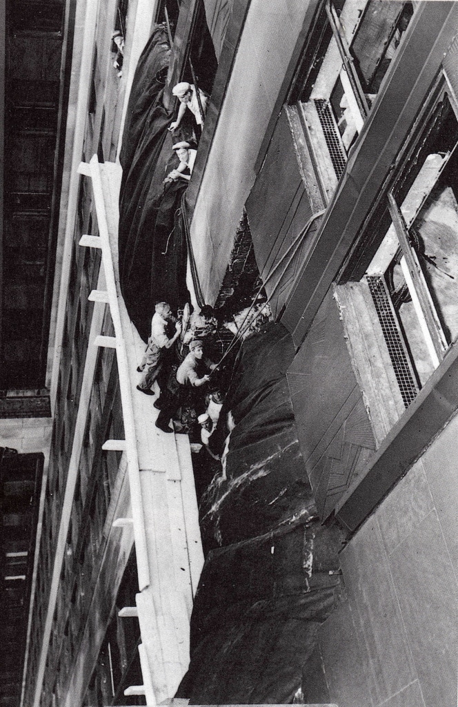 construction workers work to repair the damage.