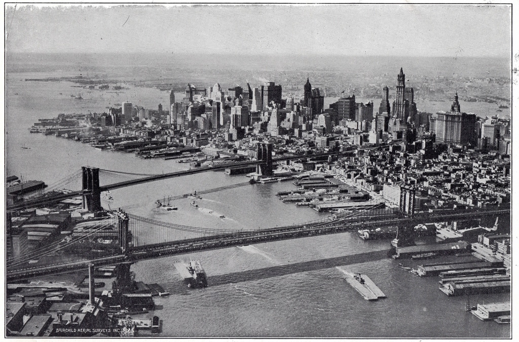 View across the East River, taking in Manhattan and Brooklyn bridge (1928).