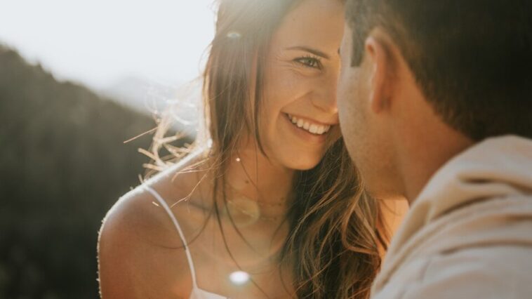 man and woman kissing during daytime